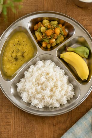 Colourful healthy South Indian meal served in a child's compartment plate